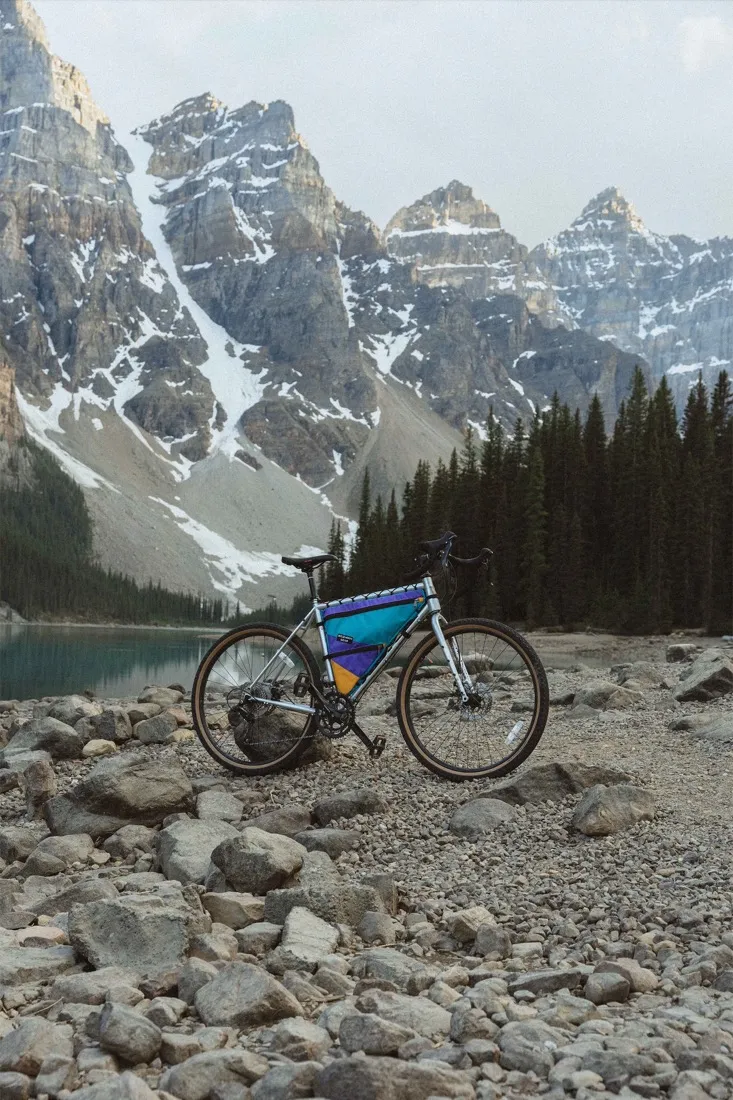 A bike with a Wild North Gear frame bag at a mountain lake