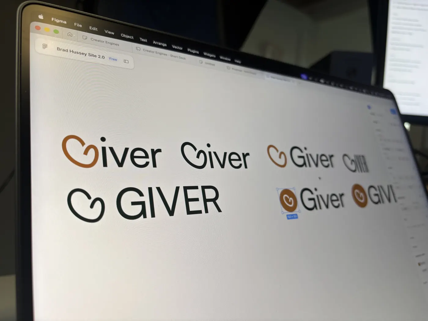 Giver wordmark options in rust and green on a laptop screen